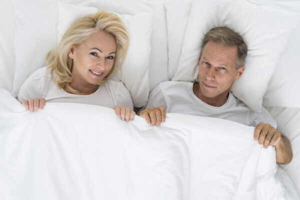 top-view-cute-couple-sitting-bed