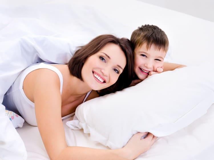 happy-cheerful-mother-her-pretty-son-lying-bed-1